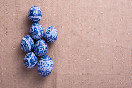 Happy Easter day eggs on brown cloth background with copy space.の写真素材