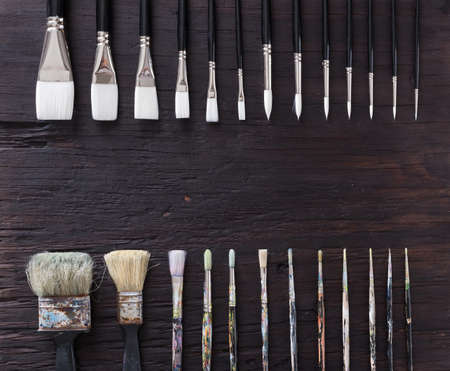 Paint brush on old wood black vintage aged texture background.の写真素材