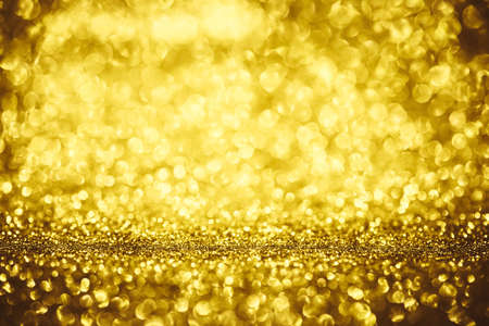 Golden glitter bokeh lighting texture Blurred abstract background for birthday, anniversary, wedding, new year eve or Christmasの写真素材