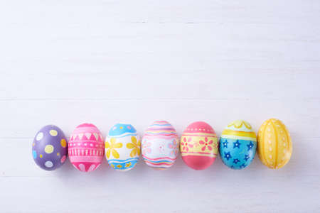 Happy Easter day eggs on wood background with copy space.