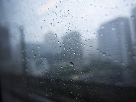 rain drop on the window in cityの写真素材