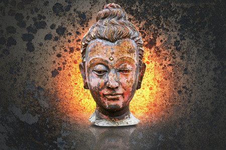 Head of buddha image isolated on art grunge backgroundの写真素材