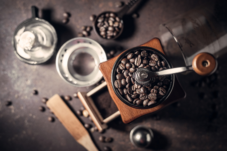Japanese siphon coffee maker and coffee grinder on old kitchen tableの写真素材