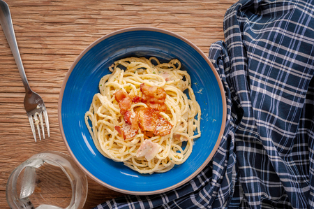 Tradition Italian food pasta carbonara, Spaghetti with bacon, ham and parmesan cheese on wooden table.の写真素材