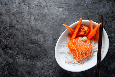 Salmon sashimi and imitation crab stick in Japanese style with kimchi, wasabi.の写真素材
