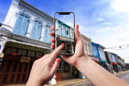 Phuket Town, Phuket, Thailand %u2013 April 22, 2018: Female hands holding phone and taking photo of...