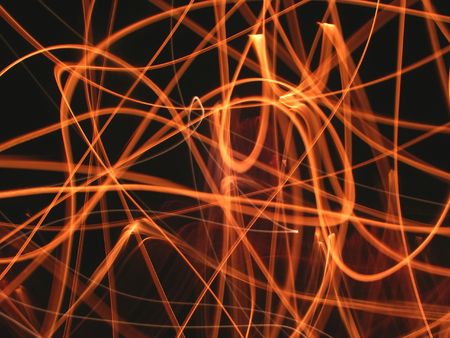 Streaks of flame light up the nightの写真素材