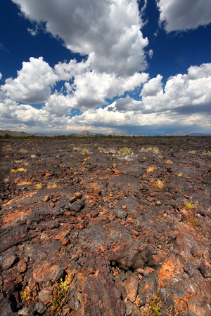 Jagged volcanic rock stretches far into the landscape at Craters of the Moon National Monument of Idahoの写真素材