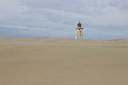 A landscape shot of a desert lighthouse on a sunny day