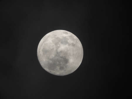 A beautiful closeup shot of the full moon in the dark night skyの写真素材