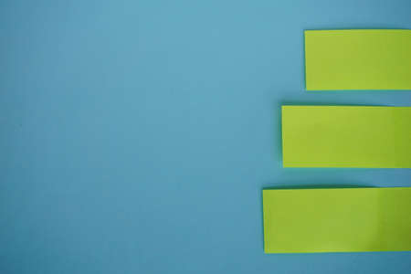 A high angel shot of note blanks on blue tableの写真素材