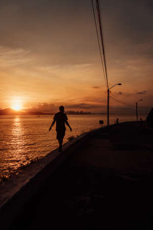 A beautiful view of a male silhouette walking on the streets in Rio at sunsetの写真素材