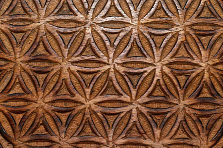 A closeup shot of the flower of life symbol made on mango wood