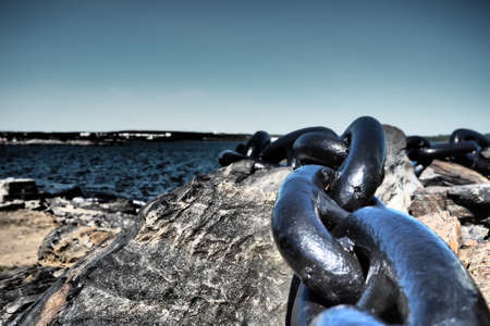 A closeup of big heavy iron chain of anchorの写真素材