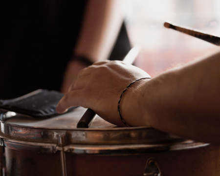 A white man playing timbales with blurred backgroundの写真素材