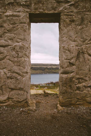 A vertical shot of a stone window of the fortressの写真素材