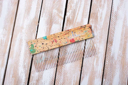 An overhead shot of a brush on a wooden surface - perfect for background
