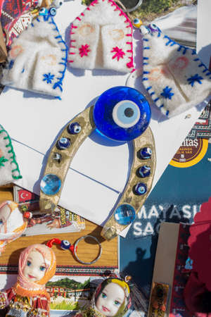 A vertical closeup shot of evil eye horseshoe among other souvenirsの写真素材