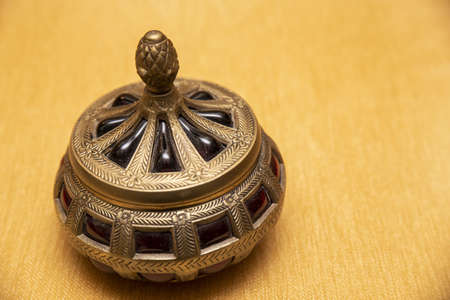 A high angle shot a beautiful decorative vintage pot on a textured surfaceの写真素材