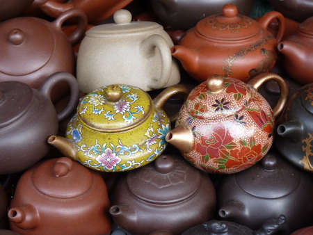 A horizontal shot of beautiful little teapots with ornamentsの写真素材