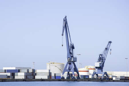 A sunny scenery of tower cranes in a big harbor