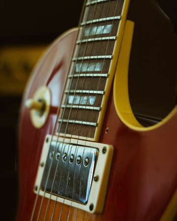 A closeup shot of an electric guitar with a blurred backgroundの写真素材