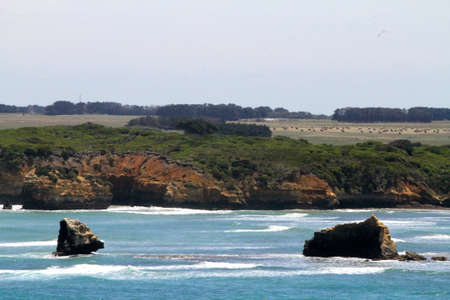 A beautiful scenery of a peaceful sea surrounded by rocky cliffs