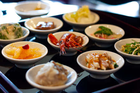 A close up shot of various delicious foods in small plates ready for degustationの写真素材
