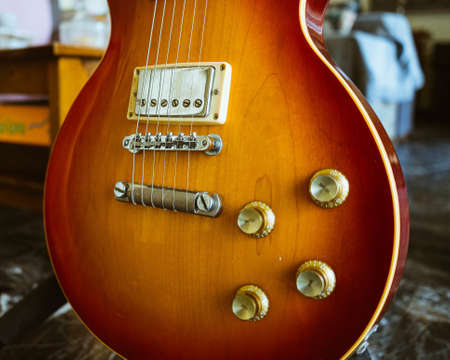 A closeup shot of an electric guitar with a blurred background