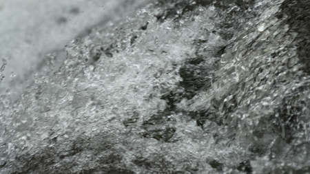 A closeup shot of a running water stream at daytime - perfect for background