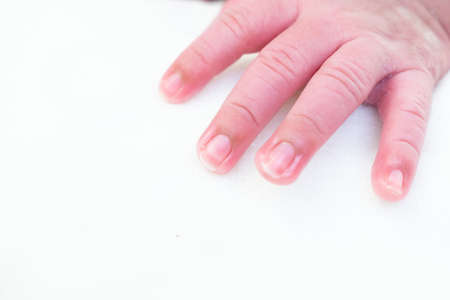 A closeup of the hand of a newborn baby under the lights isolated on a white backgroundの写真素材