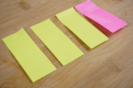 A closeup shot of colorful note blanks on wooden table