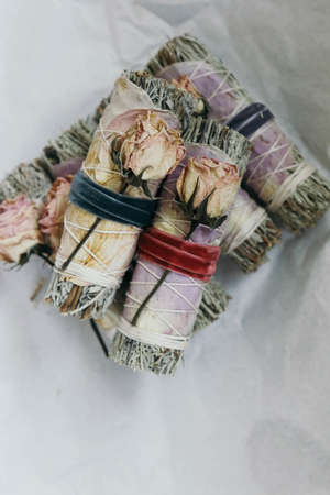 An overhead shot of beautifully arrange smudge sticks on white wrapping paperの写真素材