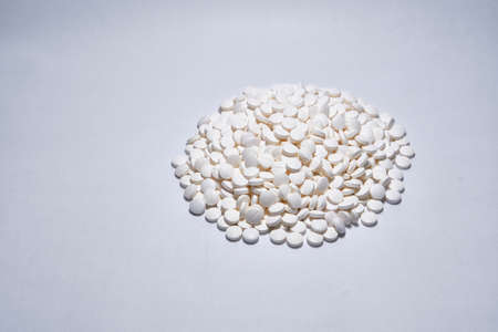 A closeup shot of white medical pills isolated on white backgroundの写真素材