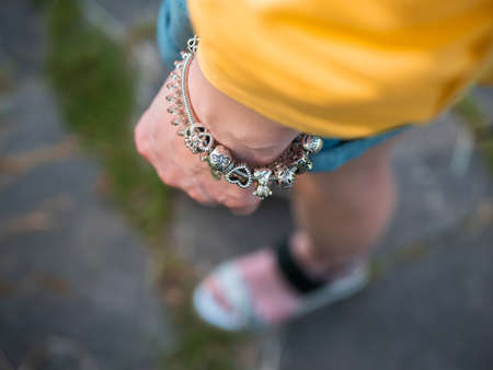 A closeup shot of a person's hand with a braceletの写真素材