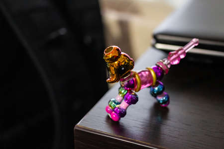 A closeup shot of twisty pet toy bracelet on a wooden tableの写真素材