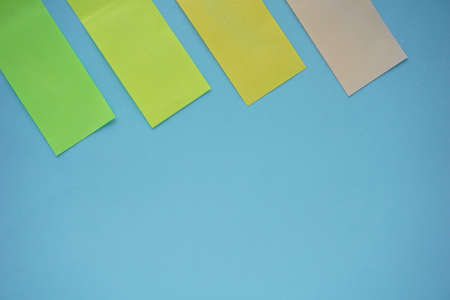 A high angel shot of note blanks on blue tableの写真素材