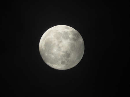 A beautiful closeup shot of the full moon in the dark night sky