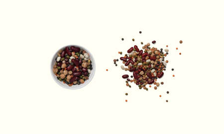 A bowl with colorful beans isolated on a beige background
