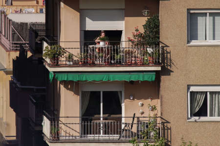 BARCELONA, SPAIN - Apr 02, 2020: People on balcony during COVID-19 confinement in Barcelona,Spain. Coronavirus Social Distancingの写真素材