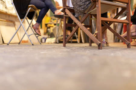 A group of artists sitting around a table and talking in a studio