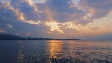 A beautiful shot a sunset sea with sun reflection and cloudy sky