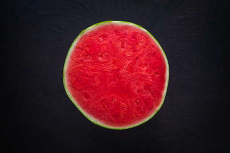 Half-cut watermelon on a dark background