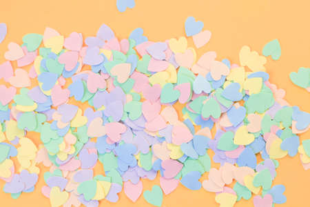 Pile of colorful hearts on an orange backgroundの写真素材