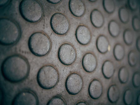 An extreme closeup of a metal manhole with a grungy textureの写真素材