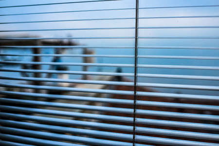 A closeup shot of open window blinds with blurred backgroundの写真素材