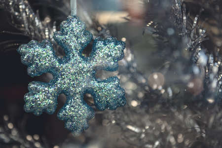 A closeup shot of a snowflake Christmas tree decorationの写真素材