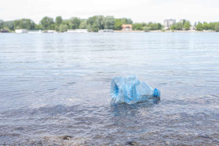 A rocky beach with plastic pollution - environmental pollution concept