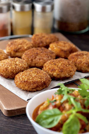 A closeup shot of dip fried crispy patties on a tray
