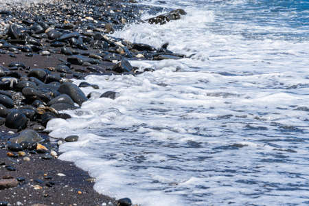 A beautiful scene of splashing waves on seashore under the sunlight